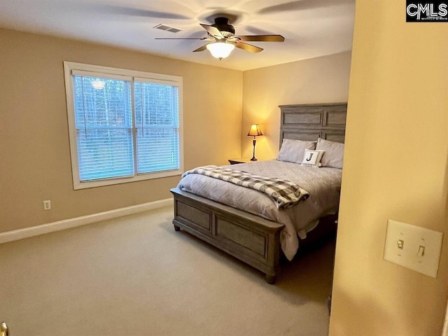 bedroom with baseboards, ceiling fan, visible vents, and light colored carpet