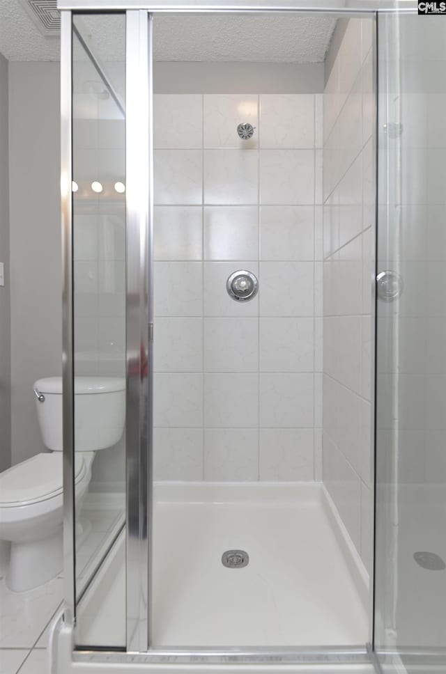 full bathroom with a textured ceiling, visible vents, a stall shower, and toilet