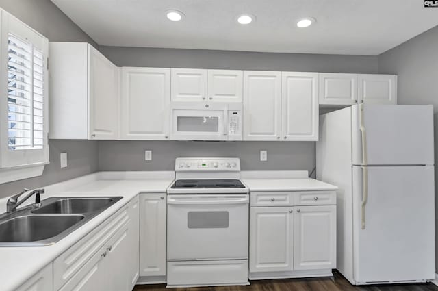 kitchen with recessed lighting, white appliances, a sink, white cabinets, and light countertops