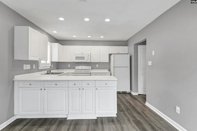 kitchen featuring white appliances, baseboards, white cabinets, light countertops, and a sink