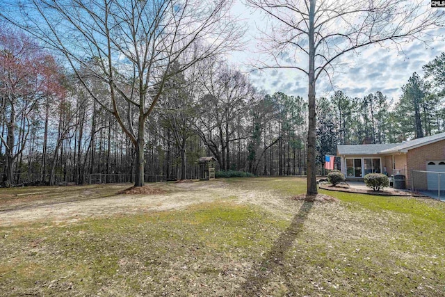 view of yard featuring driveway and an attached garage