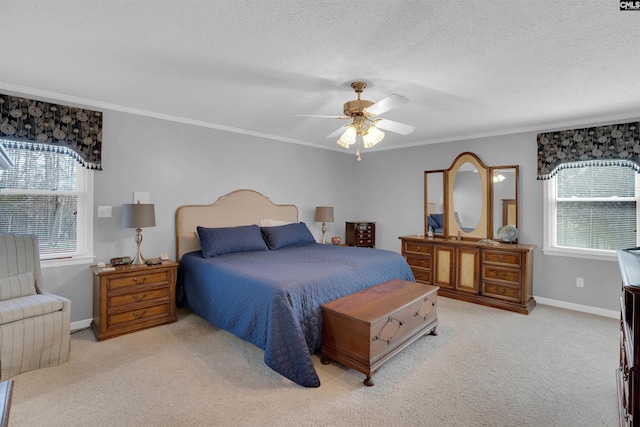 bedroom featuring crown molding, a textured ceiling, and light colored carpet