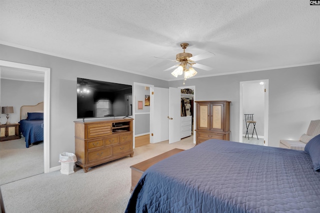 bedroom featuring light carpet, a textured ceiling, a ceiling fan, and crown molding