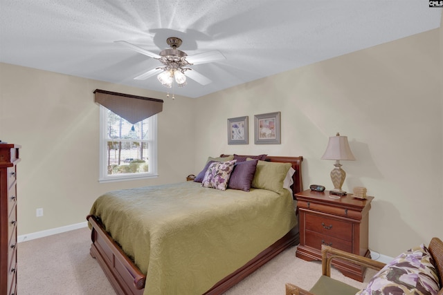 bedroom featuring baseboards, a ceiling fan, and light colored carpet