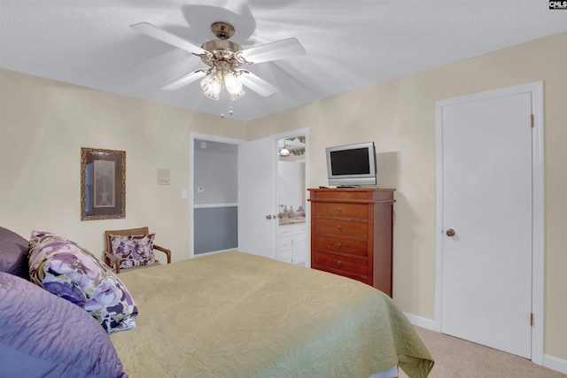 bedroom with ceiling fan, a textured ceiling, carpet flooring, and ensuite bathroom