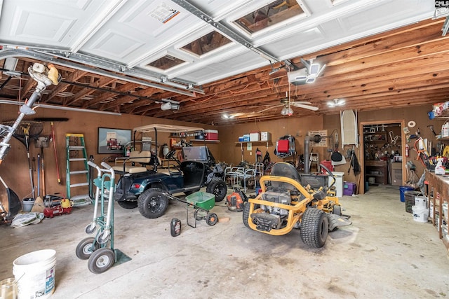 garage with a workshop area and a garage door opener