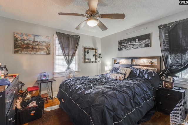 bedroom featuring a ceiling fan and a textured ceiling