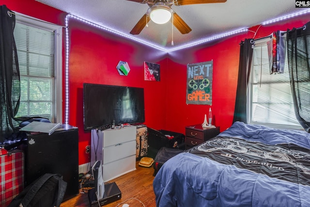 bedroom with ceiling fan and wood finished floors