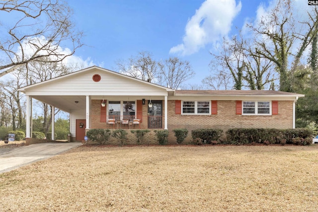 single story home featuring a porch, an attached carport, brick siding, driveway, and a front yard