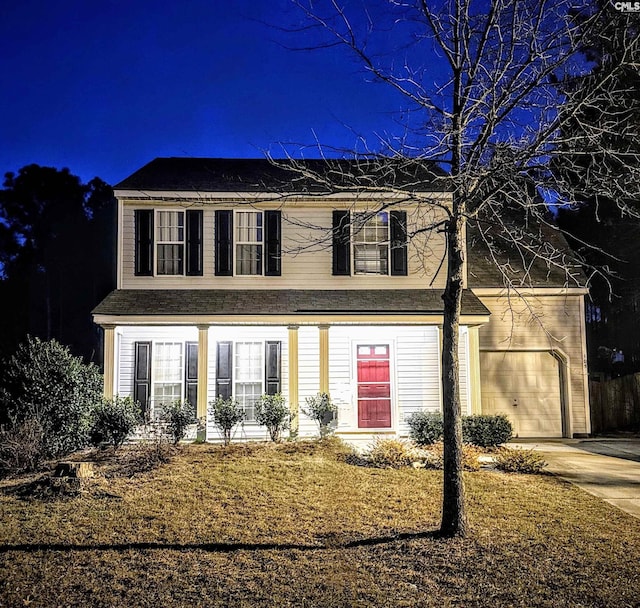 traditional home with a garage and concrete driveway