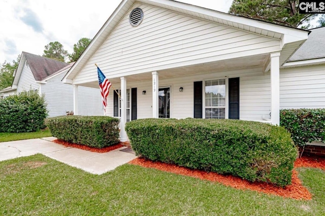 bungalow with a front lawn and a porch