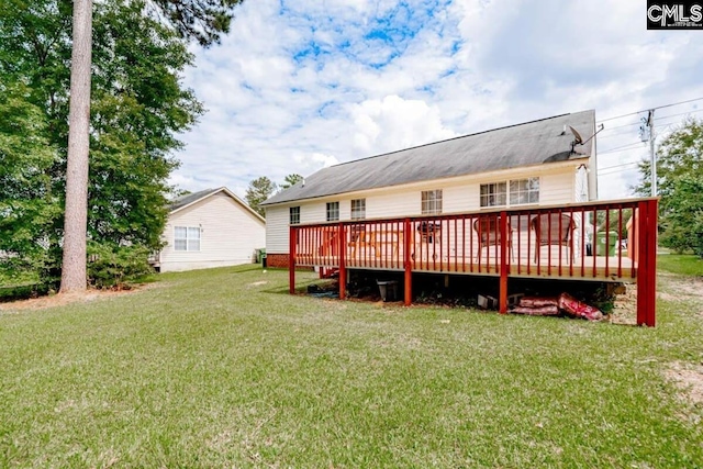 back of property featuring a yard and a wooden deck