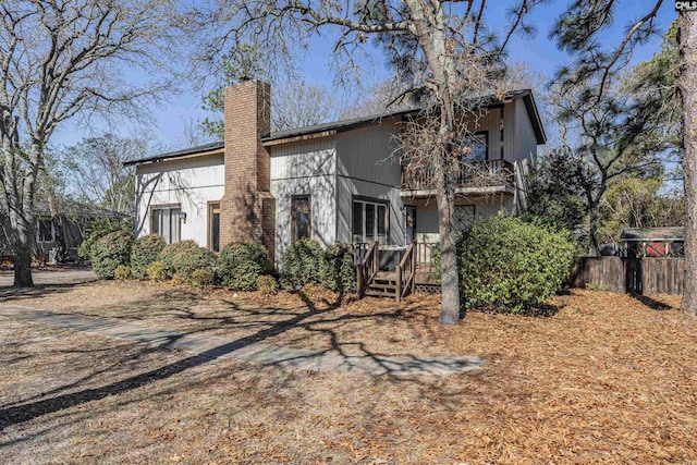 exterior space with fence and a chimney