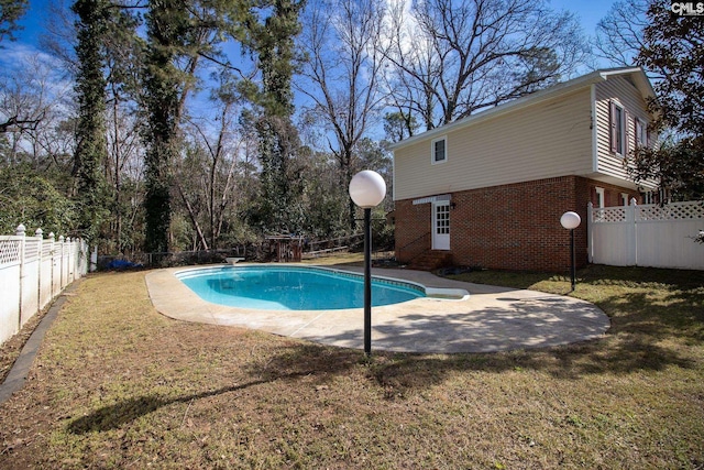 view of swimming pool with a fenced in pool, a fenced backyard, a lawn, and a patio