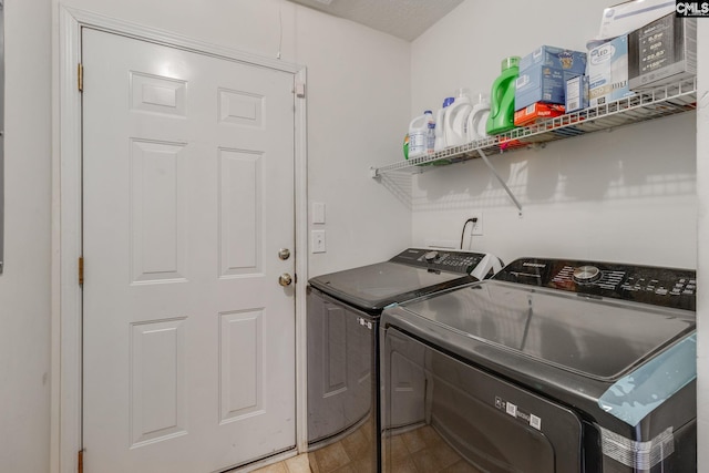 clothes washing area featuring laundry area and washing machine and clothes dryer