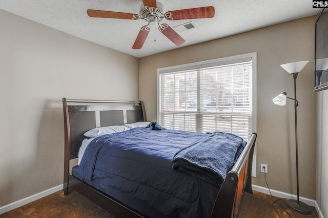 bedroom featuring visible vents, ceiling fan, a textured ceiling, and baseboards