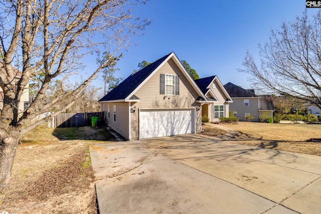 exterior space with a garage, fence, and driveway