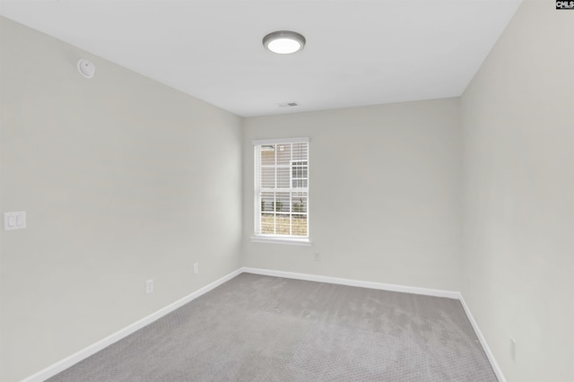 unfurnished room with carpet floors and baseboards