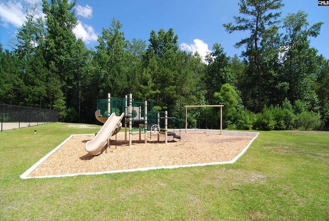 community playground featuring a lawn and fence