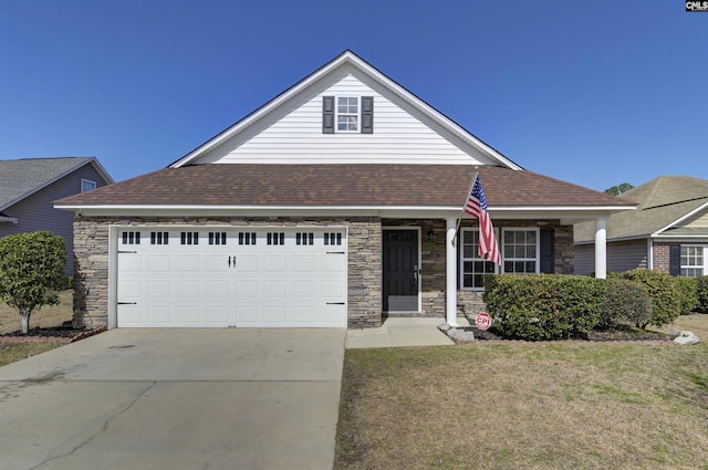 view of front of house featuring an attached garage, stone siding, a shingled roof, and driveway