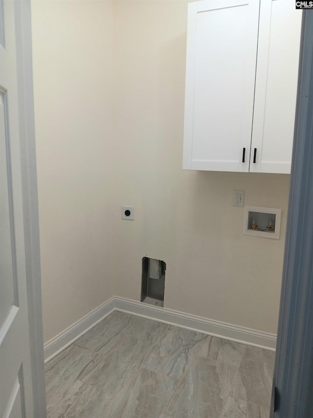 washroom with baseboards, washer hookup, cabinet space, and hookup for an electric dryer