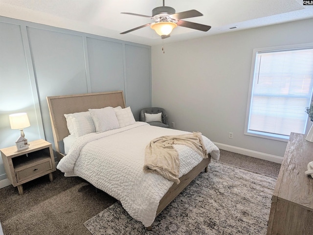 bedroom with carpet floors, ceiling fan, visible vents, and a decorative wall