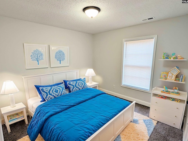 bedroom featuring a textured ceiling, dark colored carpet, visible vents, and baseboards