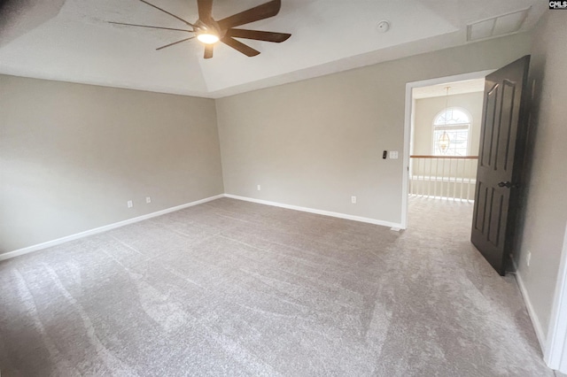 empty room featuring carpet floors, a ceiling fan, and baseboards