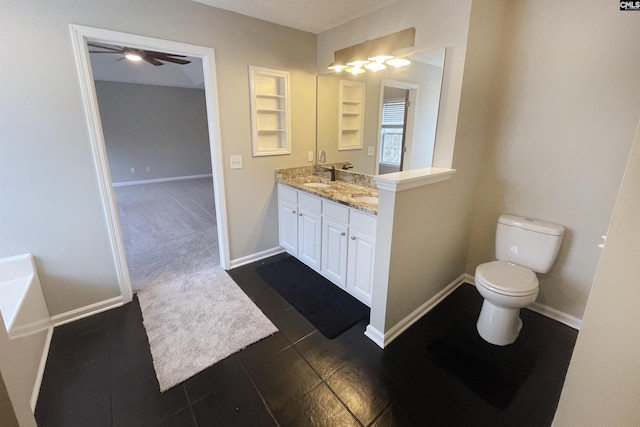 bathroom featuring double vanity, baseboards, toilet, a bath, and a sink