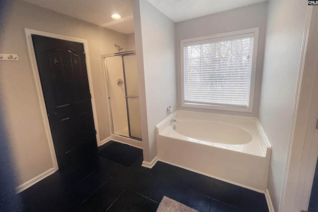 bathroom with a stall shower, recessed lighting, baseboards, and a bath