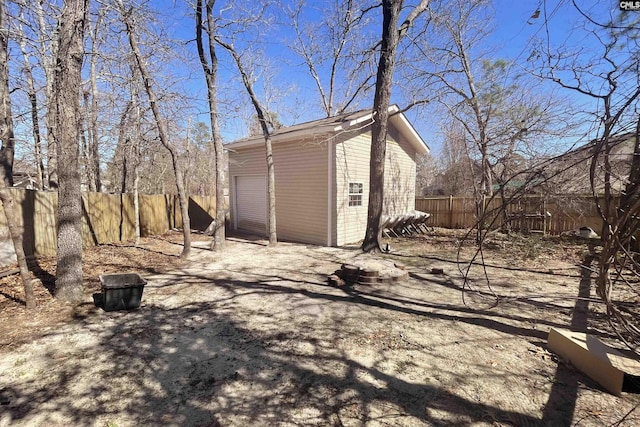 exterior space with a garage and fence private yard