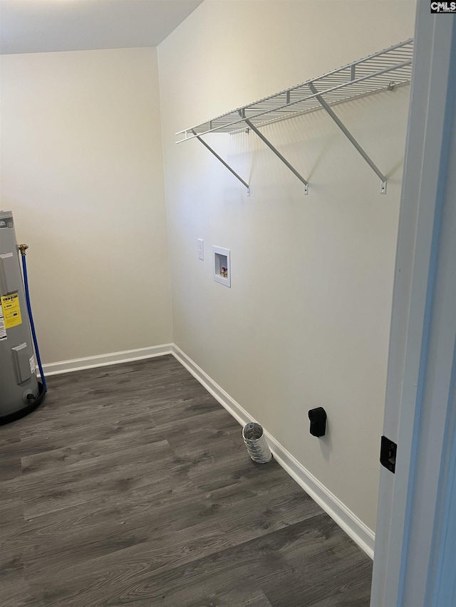 clothes washing area with laundry area, baseboards, dark wood-style flooring, electric water heater, and washer hookup