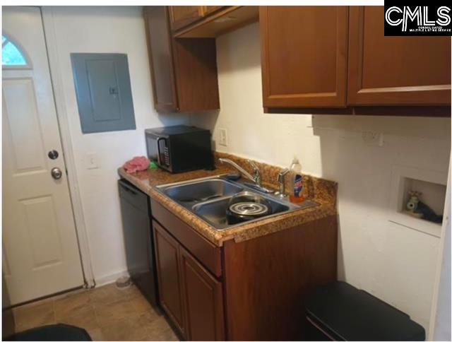 kitchen featuring black appliances, electric panel, brown cabinets, and a sink