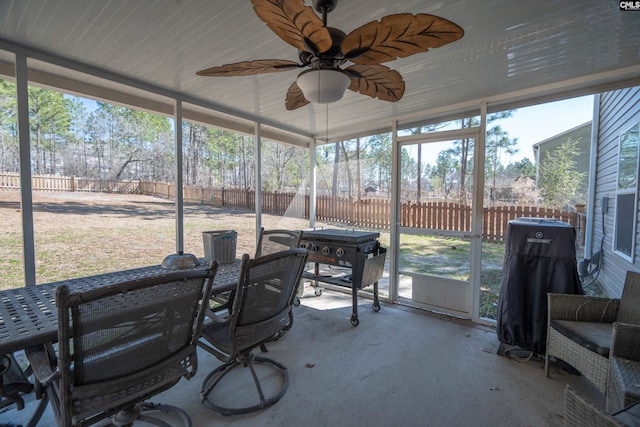 sunroom / solarium with a wealth of natural light and a ceiling fan