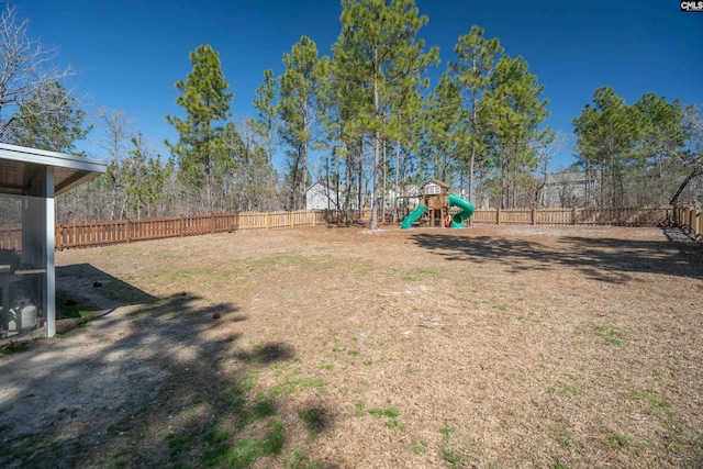 view of yard featuring a fenced backyard and a playground