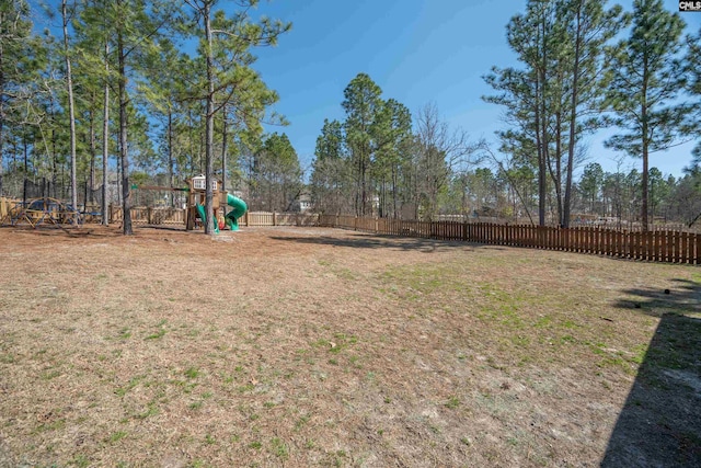 view of yard with a playground and a fenced backyard