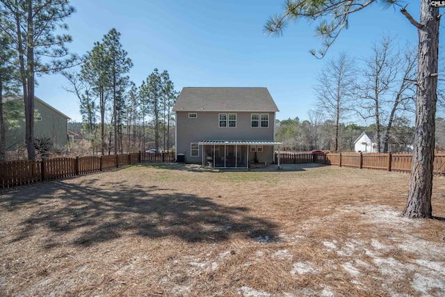 back of house with a fenced backyard