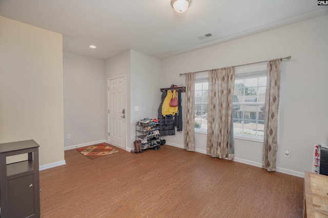 interior space featuring visible vents, baseboards, and wood finished floors