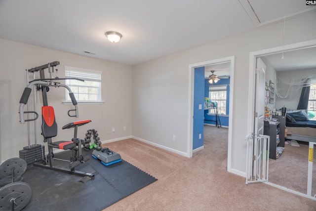 workout room featuring visible vents, a wealth of natural light, attic access, and baseboards