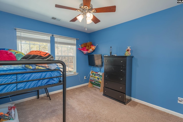 bedroom with light colored carpet, visible vents, ceiling fan, and baseboards