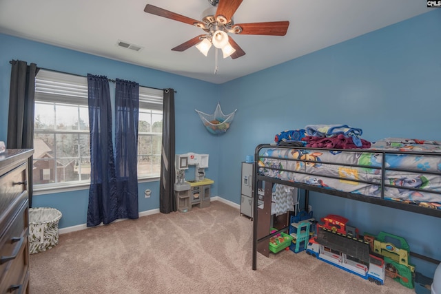 bedroom with a ceiling fan, light colored carpet, visible vents, and baseboards