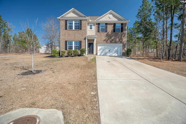 view of front of property with driveway, a garage, and brick siding