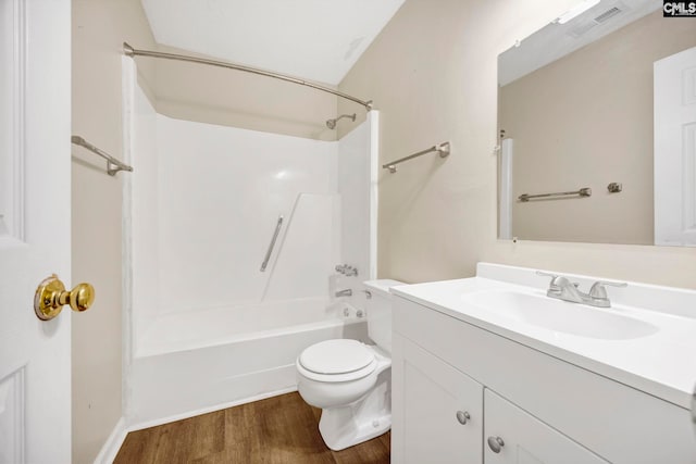 full bathroom with visible vents, toilet, vanity, wood finished floors, and  shower combination