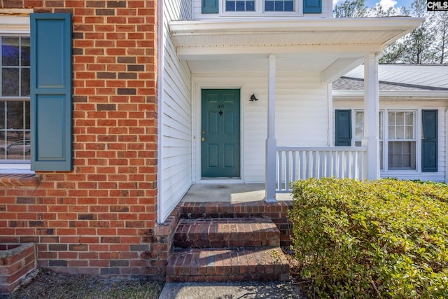 view of exterior entry with brick siding