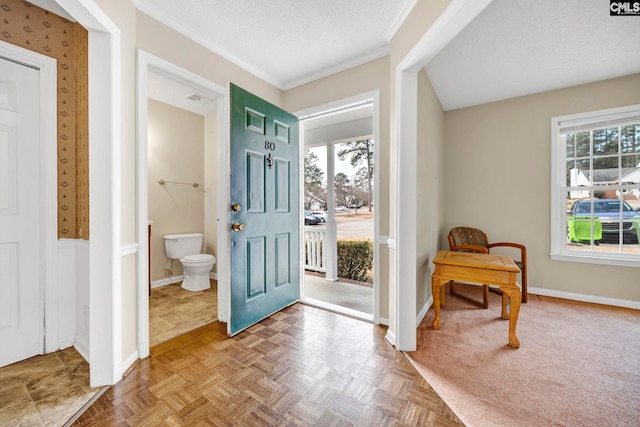 entryway featuring plenty of natural light, baseboards, and a textured ceiling