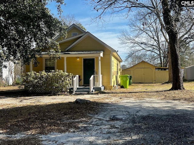 view of front of property with a shed and an outbuilding