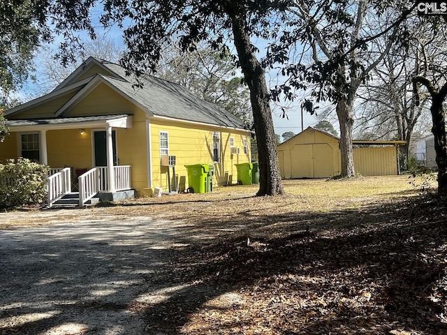 back of property with a storage shed and an outbuilding