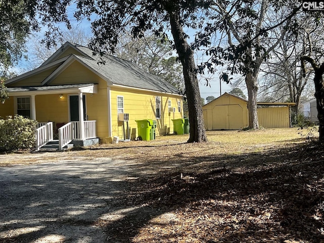 back of property with an outbuilding and a storage unit