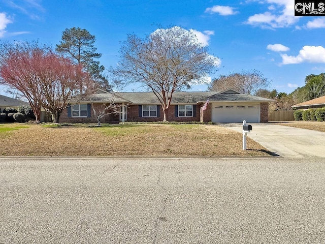 ranch-style home with a front lawn, brick siding, driveway, and an attached garage