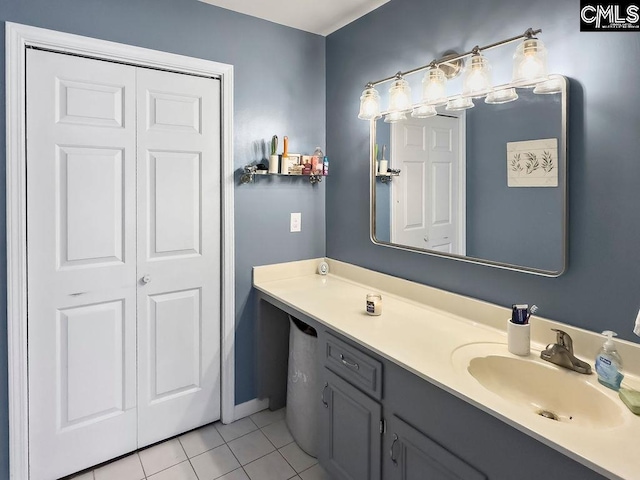 bathroom featuring tile patterned floors, a closet, and vanity